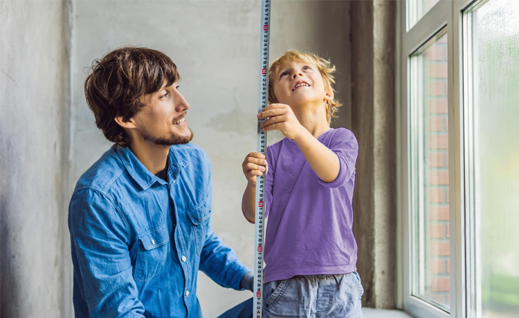 Father and child measuring
